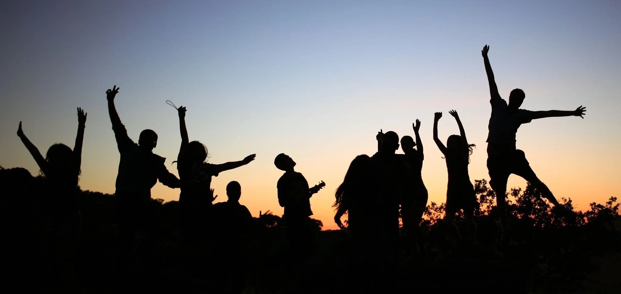 Fellows in silhouette against sunrise or sunset